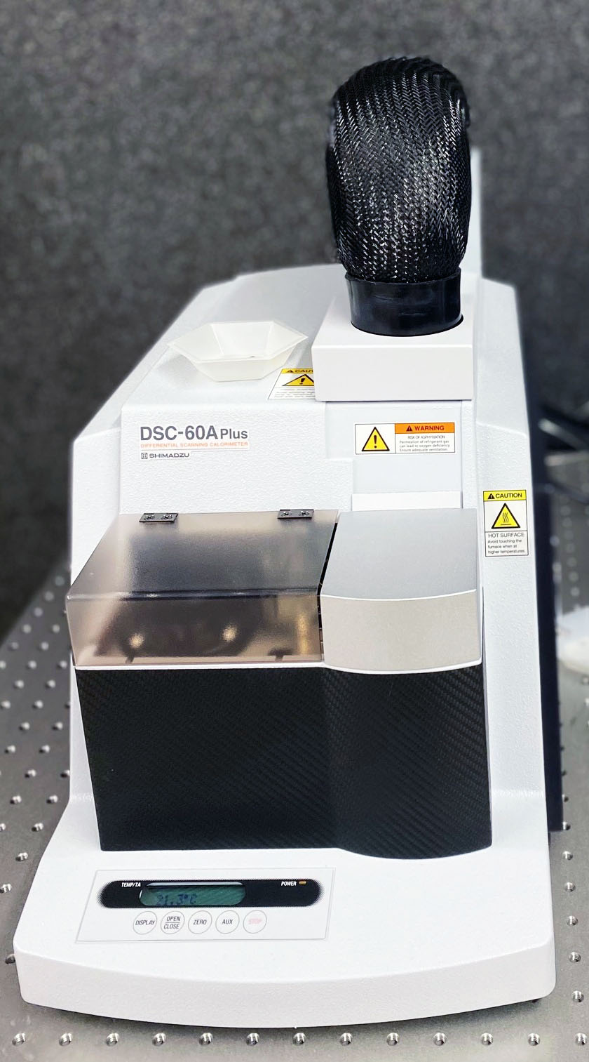 Shimadzu DSC-60A Plus differential scanning calorimeter with autosampler and warning labels.