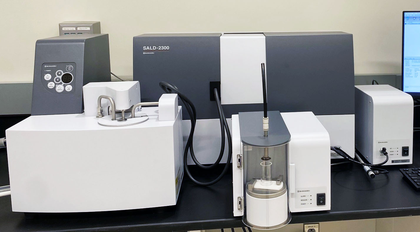 Shimadzu SALD-2300 laser diffraction particle size analyzer with sample dispersion units and connected tubing.